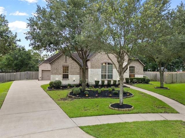 100 Anderson Ranch Ln, Friendswood, TX 77546 - view of front facade with driveway, brick siding, and a garage