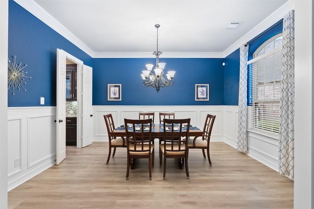 100 Anderson Ranch Ln, Friendswood, TX 77546 - dining area featuring plenty of natural light, a decorative wall, a chandelier, a wainscoted wall, and ornamental molding