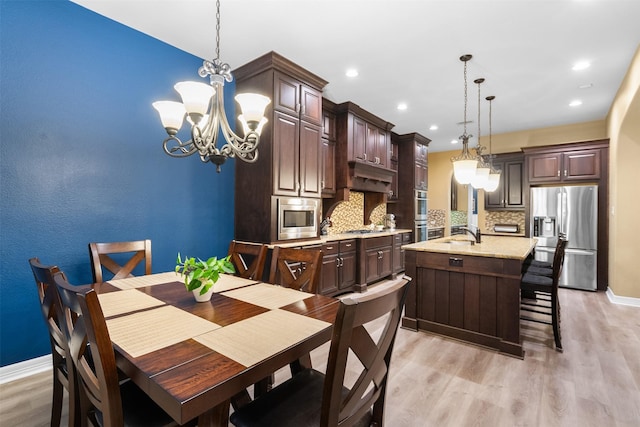 100 Anderson Ranch Ln, Friendswood, TX 77546 - dining space featuring a chandelier, light wood-type flooring, and recessed lighting