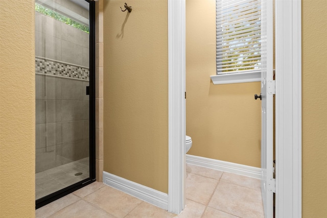 100 Anderson Ranch Ln, Friendswood, TX 77546 - full bath with tile patterned flooring, a shower stall, and a textured wall
