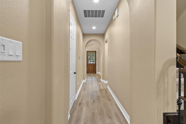100 Anderson Ranch Ln, Friendswood, TX 77546 - corridor with arched walkways, wood finished floors, a textured wall, and recessed lighting