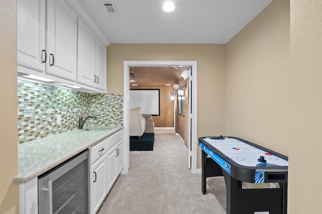 100 Anderson Ranch Ln, Friendswood, TX 77546 - rec room with wine cooler, light colored carpet, and a ceiling fan