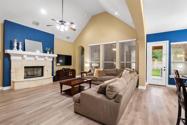 100 Anderson Ranch Ln, Friendswood, TX 77546 - living room featuring ceiling fan, arched walkways, high vaulted ceiling, wood finished floors, and a fireplace