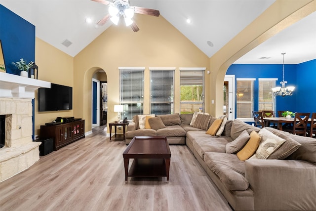 100 Anderson Ranch Ln, Friendswood, TX 77546 - living room featuring arched walkways, high vaulted ceiling, a chandelier, ceiling fan, and light wood finished floors