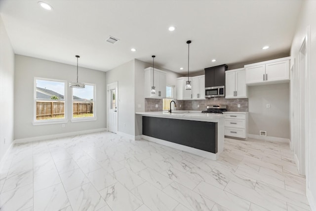 10219 Carmencita Way, Houston, TX 77075 - kitchen featuring appliances with stainless steel finishes, light countertops, light marble finish flooring, backsplash, and recessed lighting