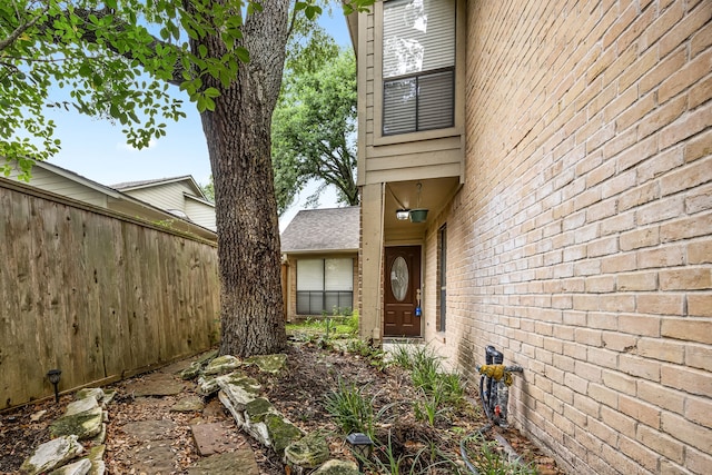 8020 Oakwood Forest Dr, Houston, TX 77040 - doorway to property featuring brick siding and roof with shingles