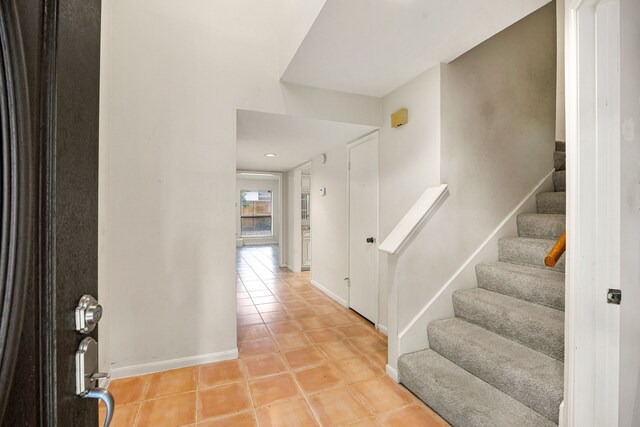 8020 Oakwood Forest Dr, Houston, TX 77040 - entrance foyer featuring light tile patterned floors and stairway