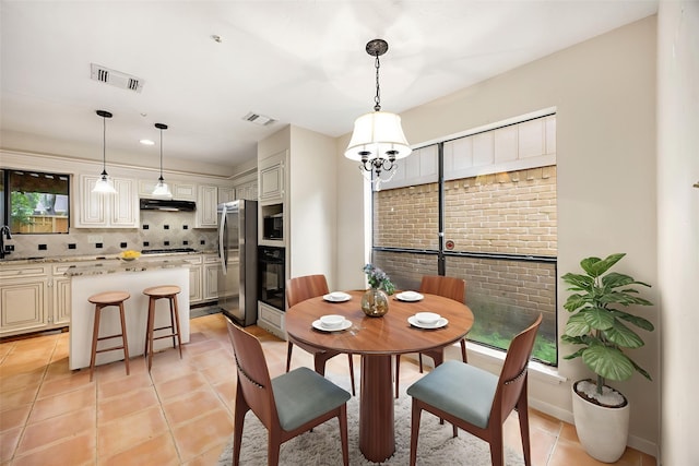 8020 Oakwood Forest Dr, Houston, TX 77040 - dining area with light tile patterned flooring and a chandelier