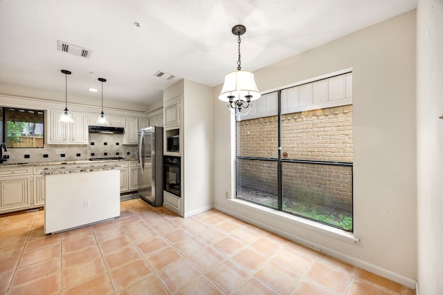 8020 Oakwood Forest Dr, Houston, TX 77040 - kitchen with stainless steel appliances, under cabinet range hood, plenty of natural light, and backsplash