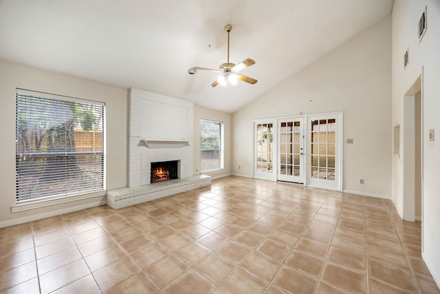 8020 Oakwood Forest Dr, Houston, TX 77040 - unfurnished living room with ceiling fan, light tile patterned floors, a brick fireplace, and high vaulted ceiling