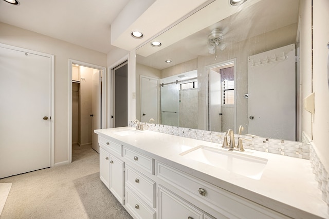 8020 Oakwood Forest Dr, Houston, TX 77040 - bathroom with a stall shower, double vanity, a ceiling fan, and recessed lighting