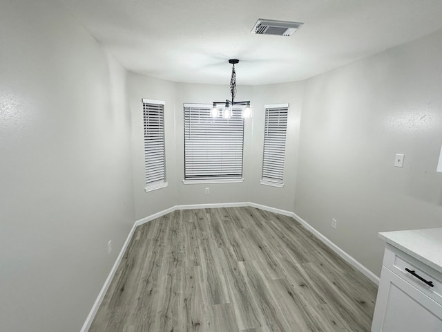 18468 Misty Wood Ln, Porter, TX 77365 - unfurnished dining area with light wood finished floors and a chandelier
