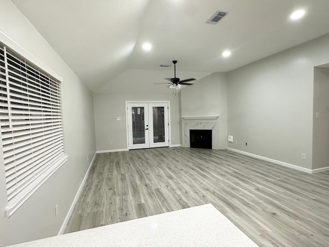 18468 Misty Wood Ln, Porter, TX 77365 - unfurnished living room with light wood-type flooring, a fireplace, lofted ceiling, ceiling fan, and recessed lighting