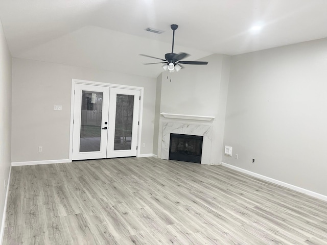 18468 Misty Wood Ln, Porter, TX 77365 - unfurnished living room with lofted ceiling, wood finished floors, ceiling fan, french doors, and a high end fireplace