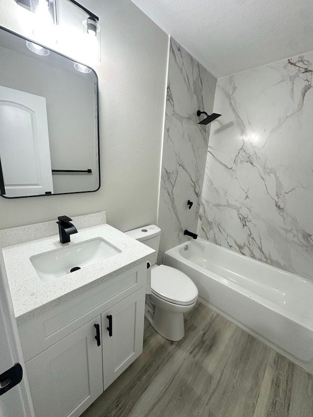 18468 Misty Wood Ln, Porter, TX 77365 - full bathroom featuring vanity, tub / shower combination, wood finished floors, and a textured ceiling