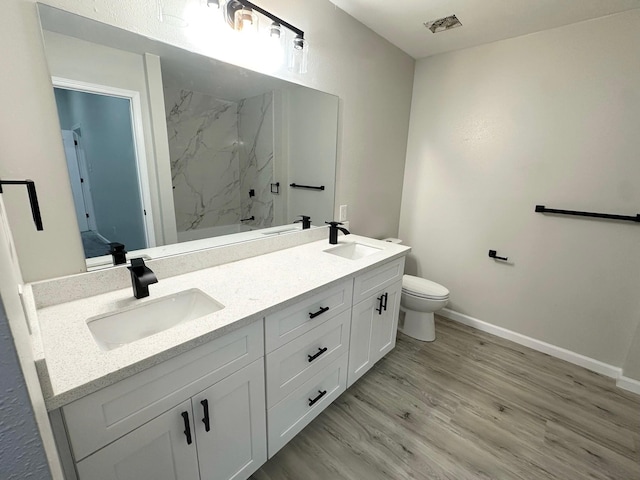 18468 Misty Wood Ln, Porter, TX 77365 - full bath with a marble finish shower, double vanity, and wood finished floors