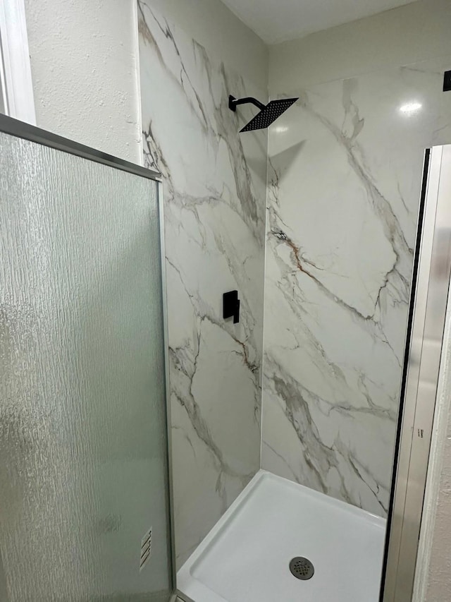 18468 Misty Wood Ln, Porter, TX 77365 - bathroom featuring a marble finish shower