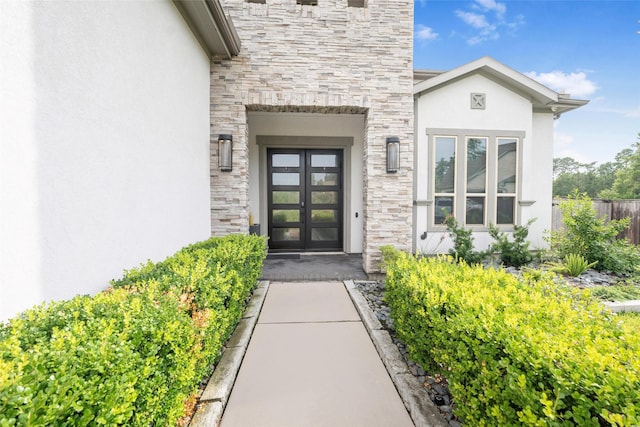 34207 Mill Creek Ct, Pinehurst, TX 77362 - doorway to property with stone siding and stucco siding