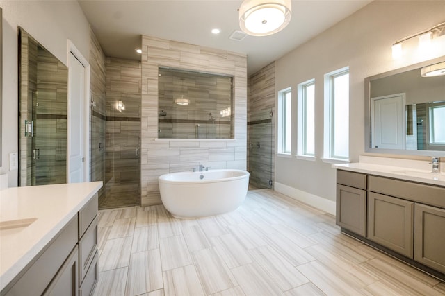34207 Mill Creek Ct, Pinehurst, TX 77362 - full bath featuring two vanities, a stall shower, and a freestanding tub