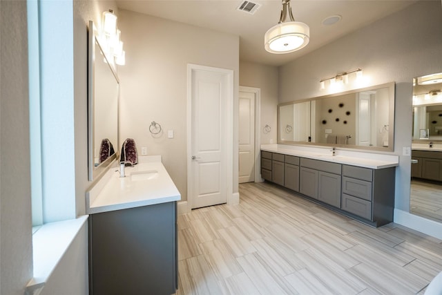 34207 Mill Creek Ct, Pinehurst, TX 77362 - bathroom featuring two vanities and baseboards