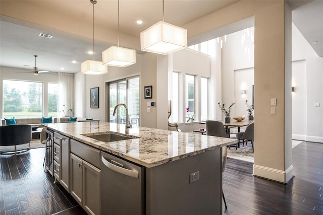 34207 Mill Creek Ct, Pinehurst, TX 77362 - kitchen featuring stainless steel dishwasher, open floor plan, an island with sink, dark wood finished floors, and recessed lighting