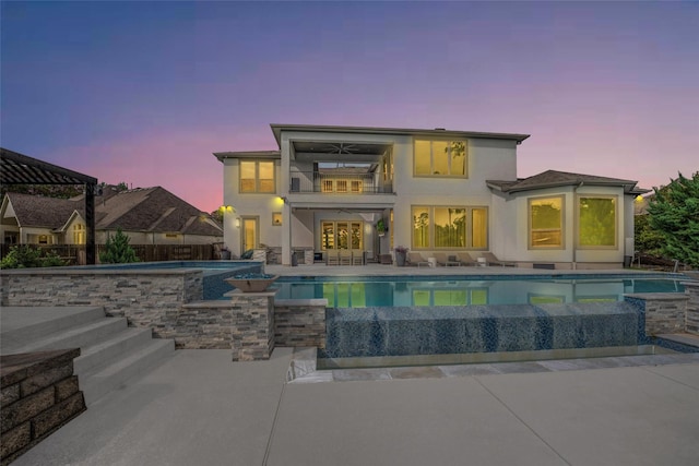 34207 Mill Creek Ct, Pinehurst, TX 77362 - back of property featuring a patio area, stucco siding, a balcony, and a pool with connected hot tub