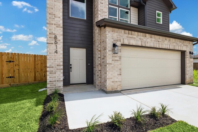 8614 Viera Ln, Houston, TX 77075 - doorway to property featuring a garage and concrete driveway