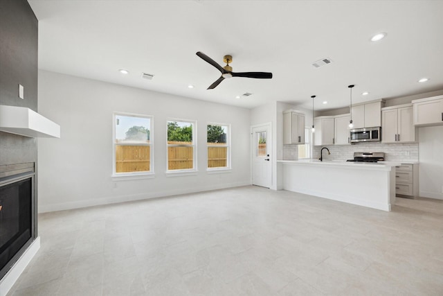 8614 Viera Ln, Houston, TX 77075 - unfurnished living room with a glass covered fireplace, a ceiling fan, and recessed lighting