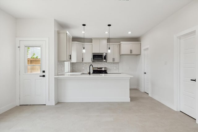 8614 Viera Ln, Houston, TX 77075 - kitchen featuring stainless steel microwave, light countertops, a peninsula, decorative backsplash, and hanging light fixtures