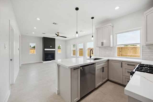 8614 Viera Ln, Houston, TX 77075 - kitchen featuring stainless steel dishwasher, a peninsula, decorative backsplash, healthy amount of natural light, and recessed lighting