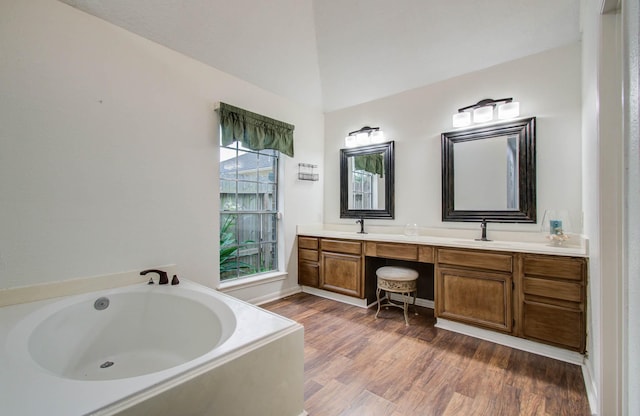 3411 Deeds Rd, Houston, TX 77084 - full bathroom with double vanity, a bath, wood finished floors, and lofted ceiling