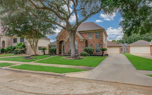 3411 Deeds Rd, Houston, TX 77084 - traditional home with brick siding, a front yard, and a detached garage