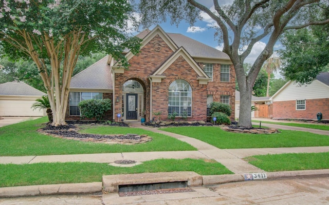 3411 Deeds Rd, Houston, TX 77084 - traditional home featuring brick siding, a front lawn, and a garage