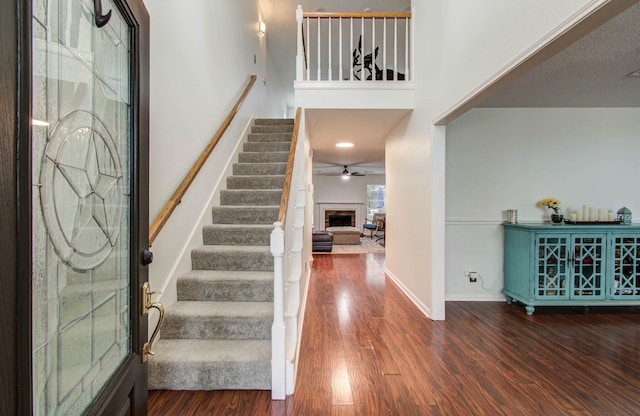 3411 Deeds Rd, Houston, TX 77084 - entryway with stairway, wood finished floors, a fireplace, and ceiling fan