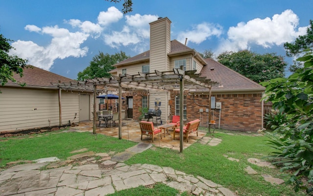 3411 Deeds Rd, Houston, TX 77084 - back of house with a pergola, a yard, brick siding, and a patio