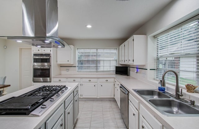 3411 Deeds Rd, Houston, TX 77084 - kitchen featuring exhaust hood, stainless steel appliances, plenty of natural light, light countertops, and recessed lighting