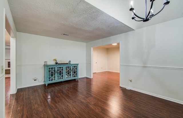 3411 Deeds Rd, Houston, TX 77084 - unfurnished living room with wood finished floors, a chandelier, and a textured ceiling