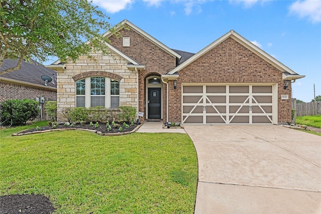19647 Travis Cannon Ln, Richmond, TX 77407 - view of front of property featuring driveway, a garage, stone siding, and brick siding