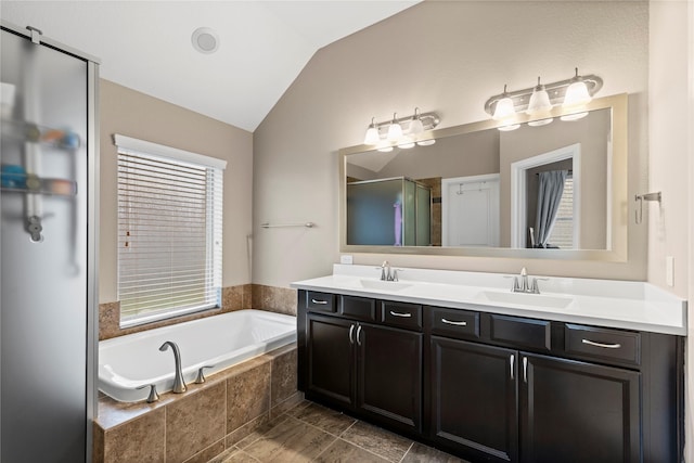 19647 Travis Cannon Ln, Richmond, TX 77407 - full bathroom with vaulted ceiling, double vanity, a bath, and a stall shower