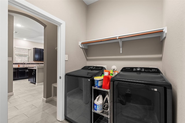 19647 Travis Cannon Ln, Richmond, TX 77407 - laundry area featuring separate washer and dryer and arched walkways