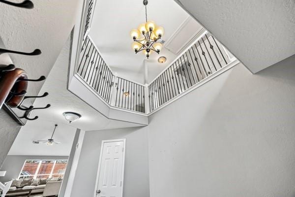 15323 Southwood Trace Ln, Houston, TX 77049 - staircase with a chandelier, a high ceiling, and ceiling fan