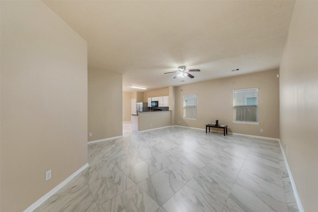 17415 Blackstone Trails Dr, Humble, TX 77396 - unfurnished living room featuring light marble finish flooring and ceiling fan