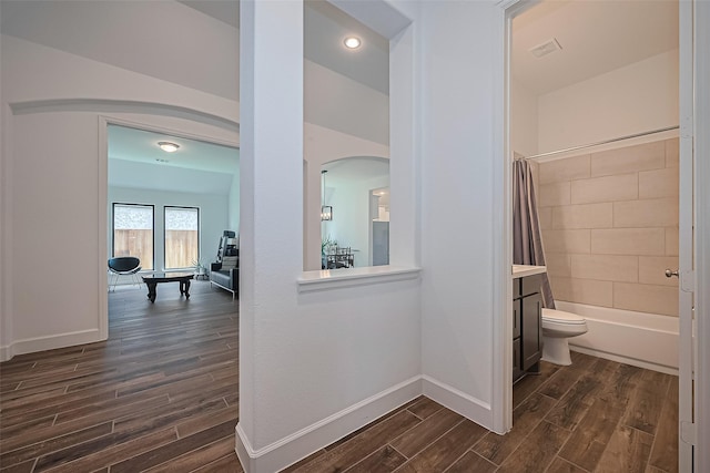 7246 Monarch Dr, Katy, TX 77493 - corridor featuring arched walkways and dark wood-style flooring