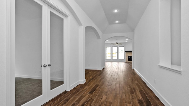 7246 Monarch Dr, Katy, TX 77493 - hallway with dark wood finished floors, arched walkways, recessed lighting, french doors, and lofted ceiling