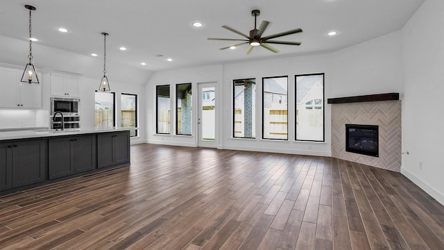 7246 Monarch Dr, Katy, TX 77493 - unfurnished living room with ceiling fan, dark wood-type flooring, recessed lighting, and a tiled fireplace