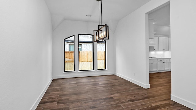 7246 Monarch Dr, Katy, TX 77493 - unfurnished dining area with dark wood-style floors, vaulted ceiling, and a chandelier