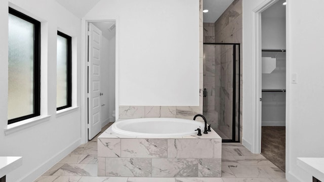 7246 Monarch Dr, Katy, TX 77493 - bathroom featuring marble look tile flooring, a bath, a shower stall, plenty of natural light, and recessed lighting