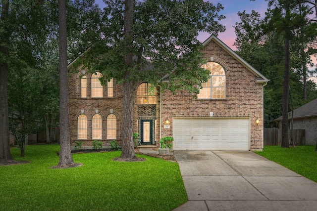 23 Murmuring Creek Pl, The Woodlands, TX 77385 - view of front facade featuring a garage, concrete driveway, and brick siding