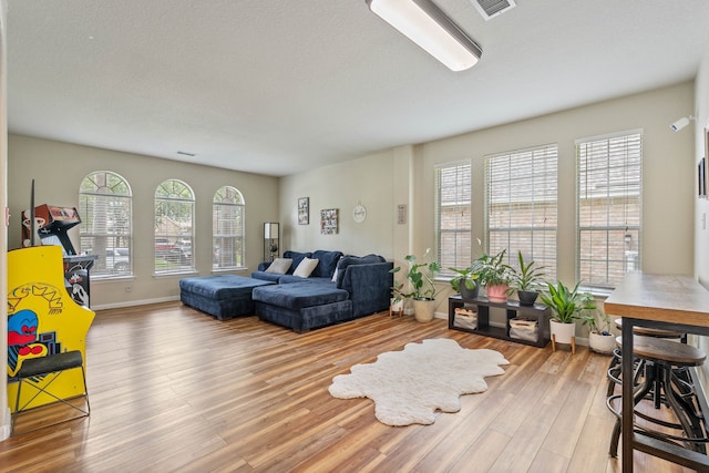 23 Murmuring Creek Pl, The Woodlands, TX 77385 - living area with light wood-style floors