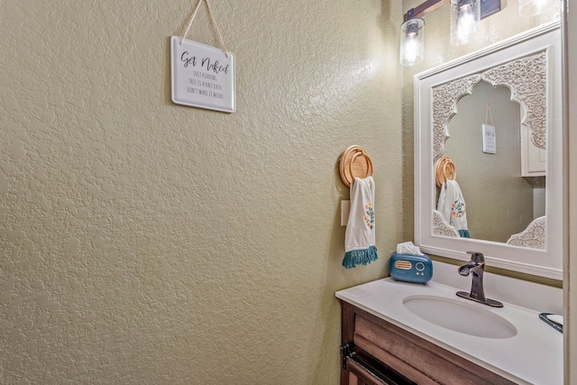 23 Murmuring Creek Pl, The Woodlands, TX 77385 - bathroom featuring vanity and a textured wall